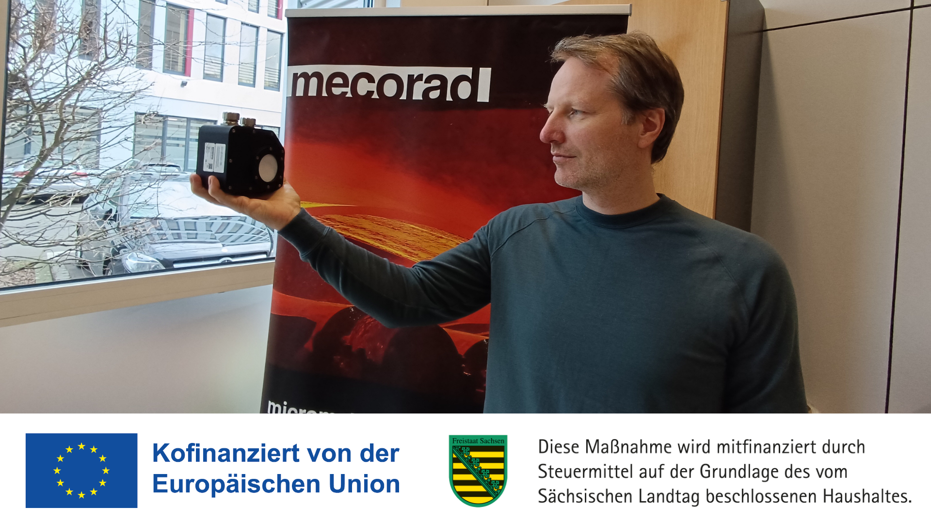 Dr. Markus Bergmann holding a sensor
